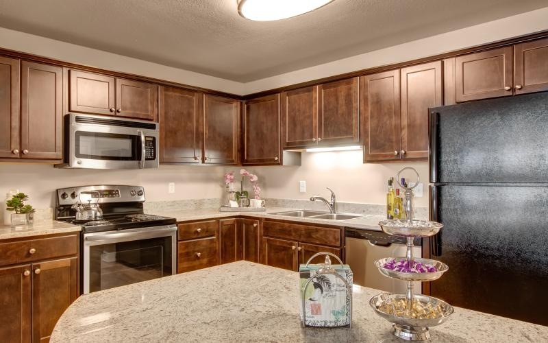 a kitchen with wooden cabinets