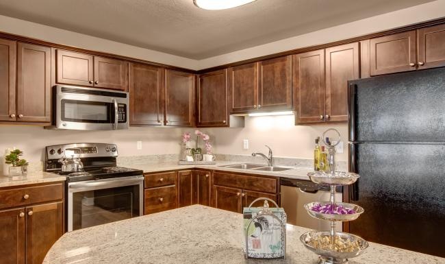 a kitchen with wooden cabinets