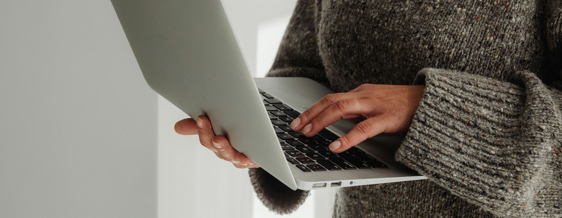 A person holding a laptop.