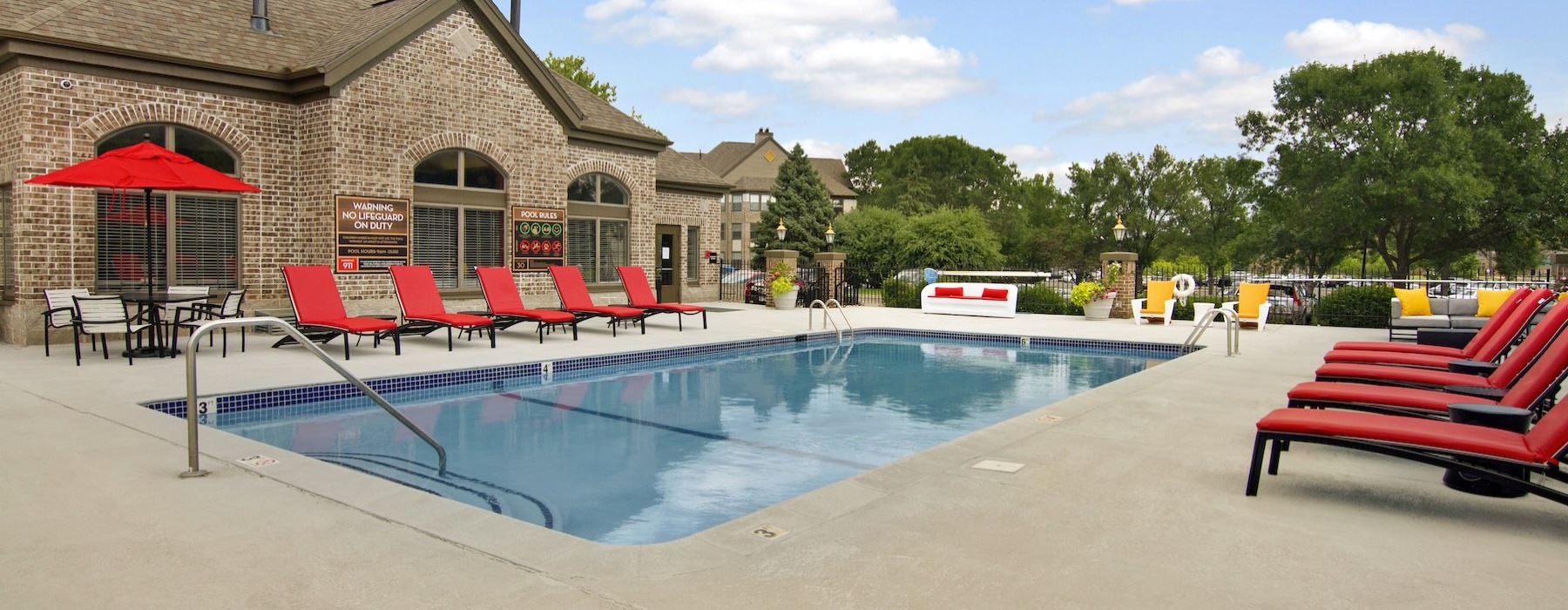 a swimming pool with chairs around it