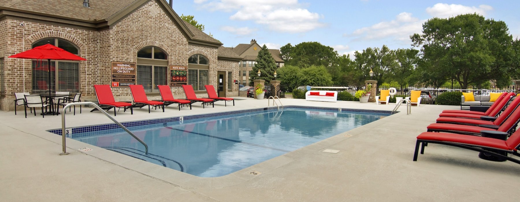 a swimming pool with chairs around it