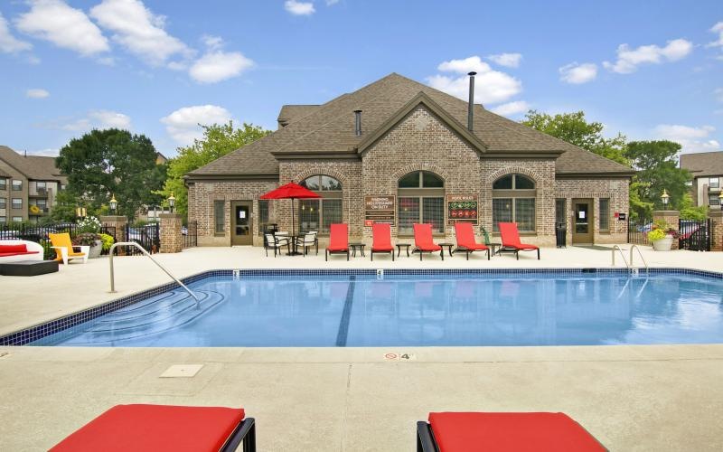 a pool with chairs and umbrellas