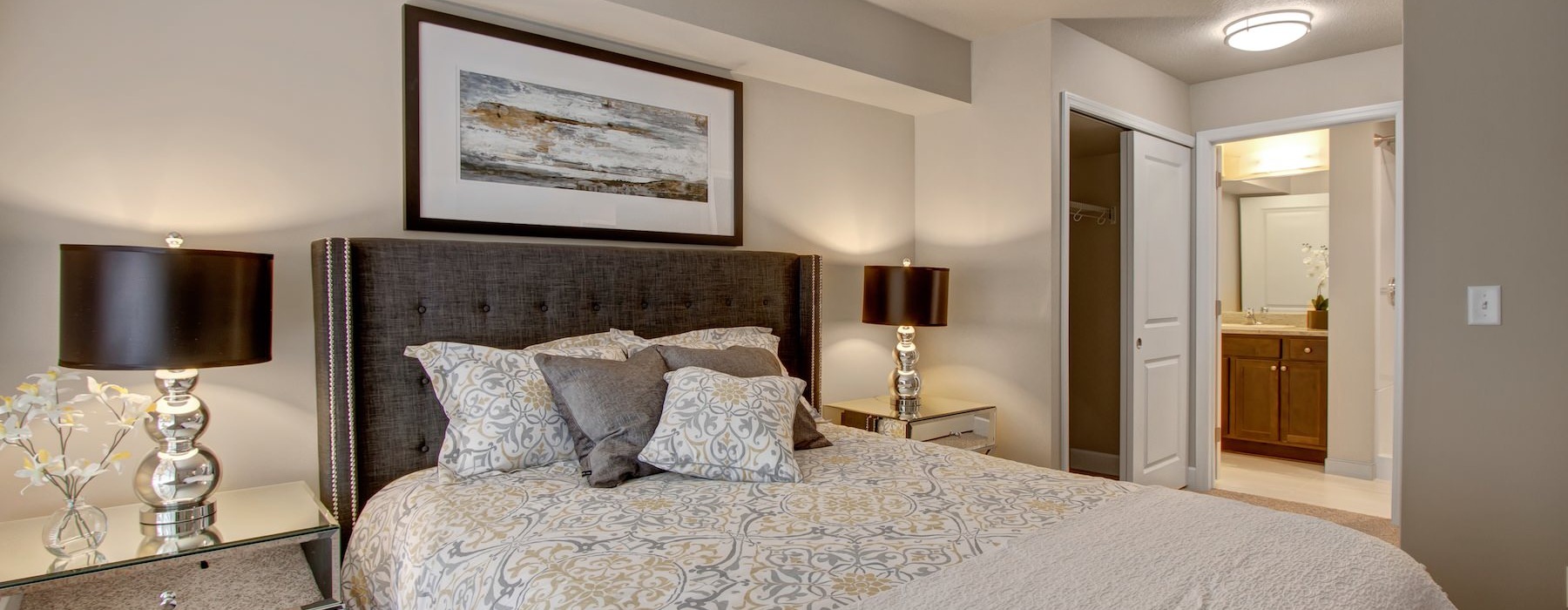 a bedroom with a bed and two nightstands