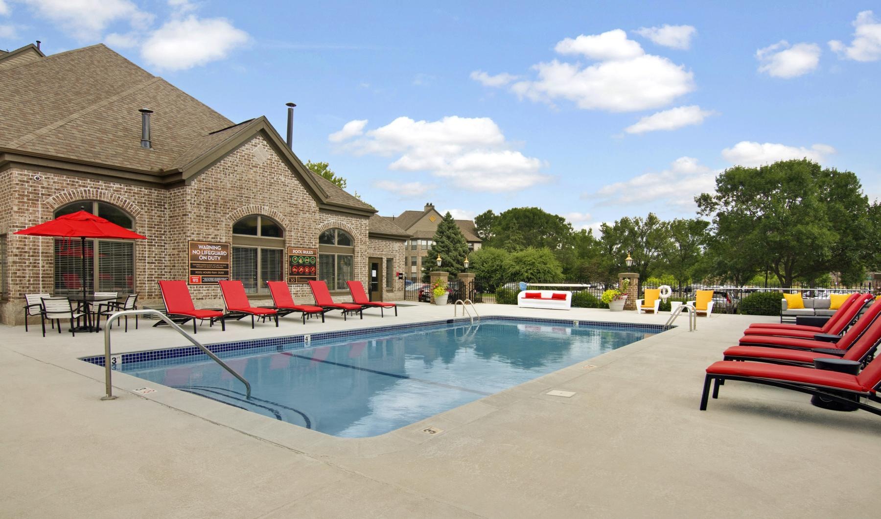 a swimming pool with chairs around it
